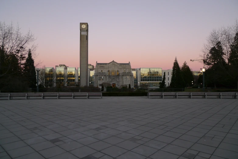 a clock tower sits in the distance in front of a building