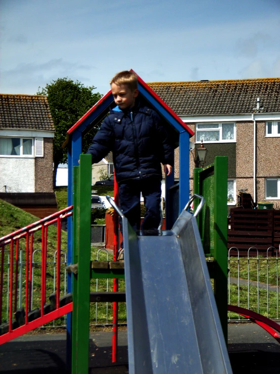 a child playing in a blue and green play area