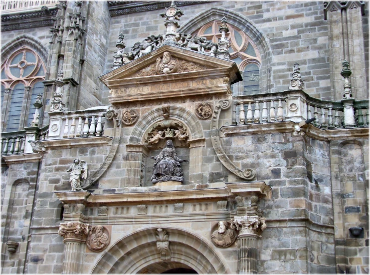 the statue is by the entrance to a church