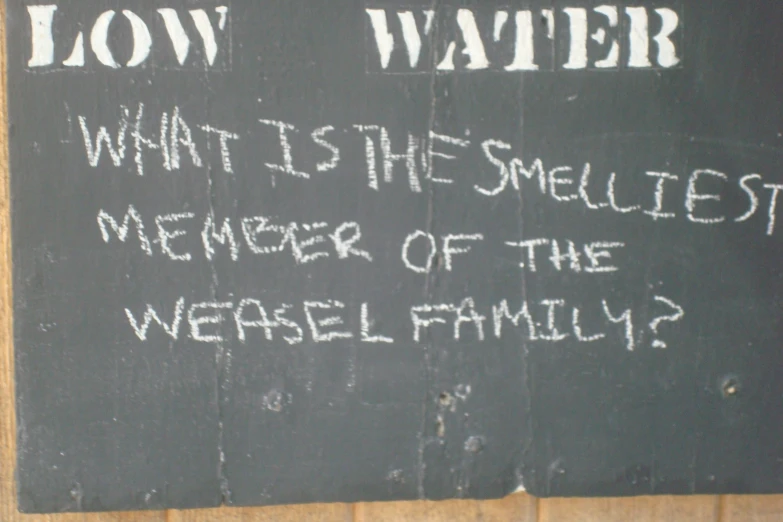 a sign on a black board that says low water