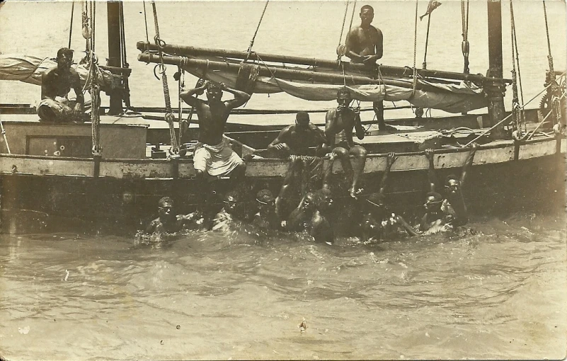 the men are standing on the bow of this boat