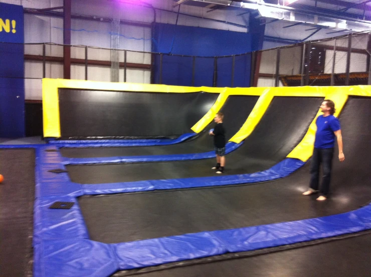 two people playing on an indoor trampoline