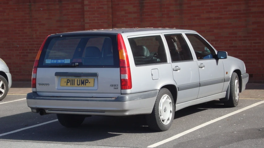 the back of a silver suv parked on a parking lot