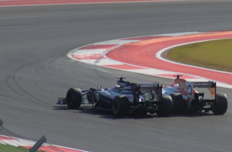 a person riding a race car on a racing track