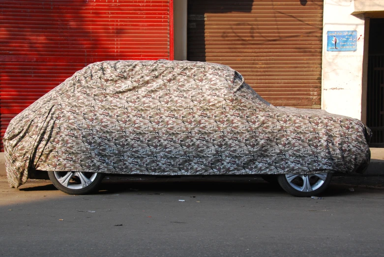 a parked car covered with a floral cloth
