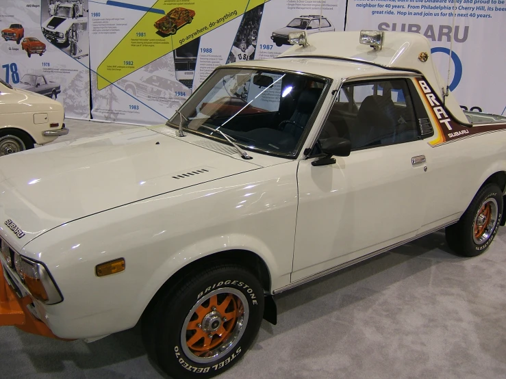 a white car sitting on top of a museum floor