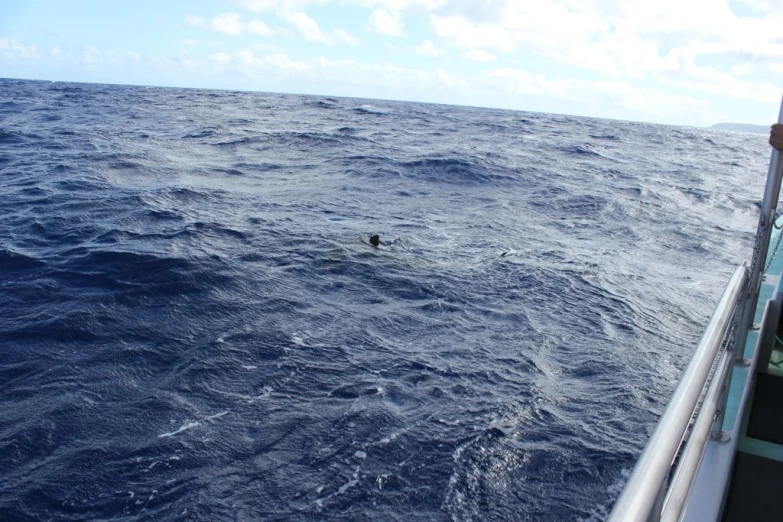 a large open body of water with a small object floating on top of it