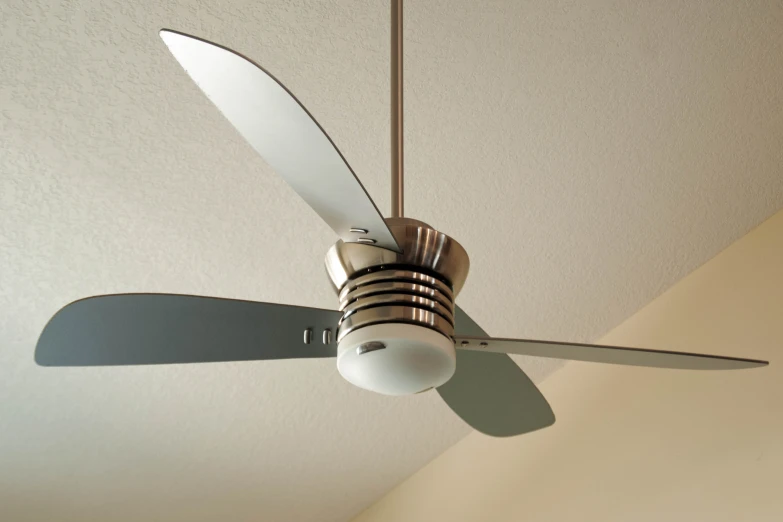 an old ceiling fan with two blades hangs from the ceiling