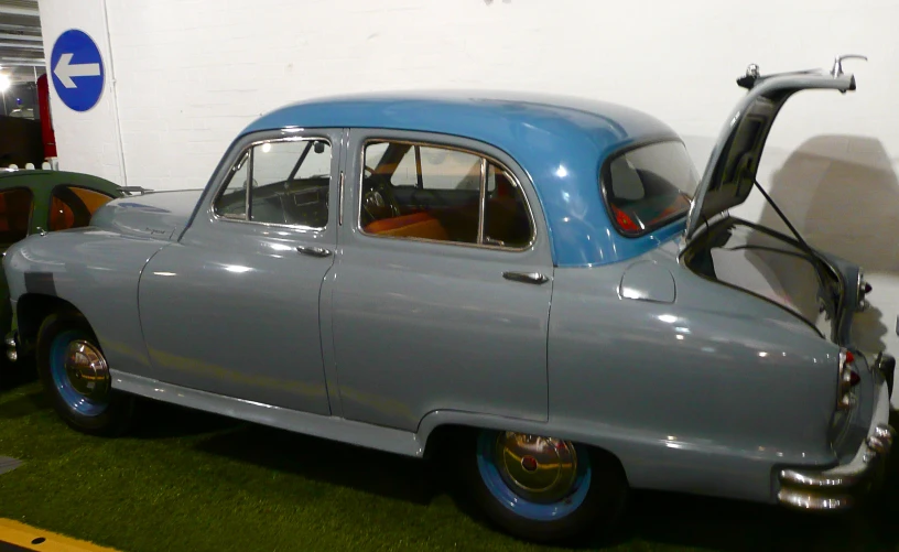 a gray car in a garage on the side of the road