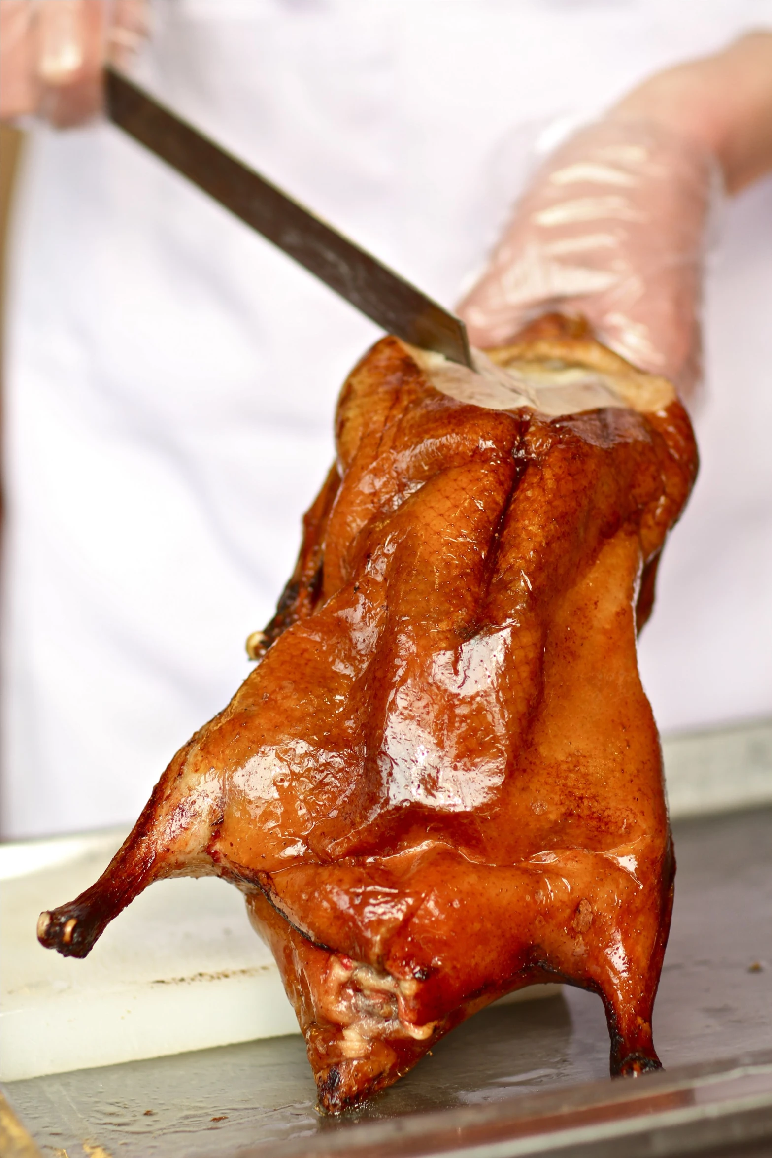 a person cooking meat on top of an open grill