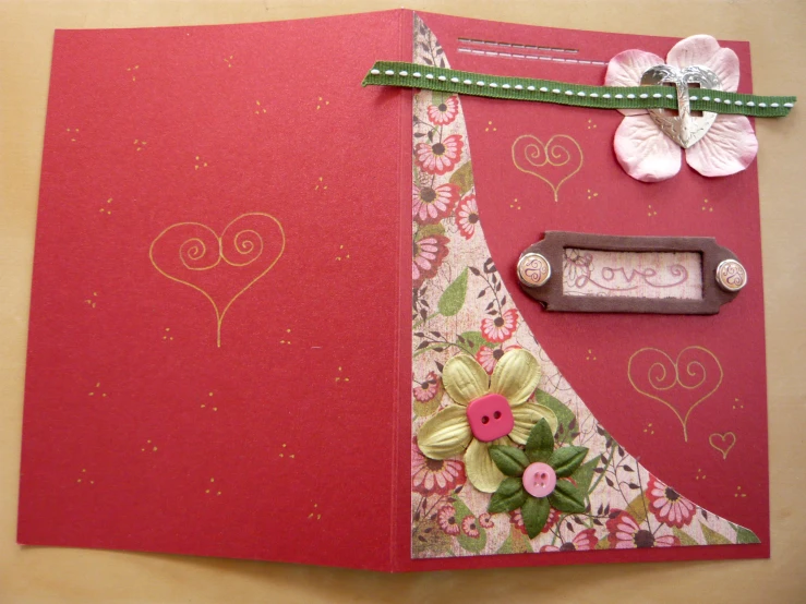 an open pink, red and white greeting card with ons