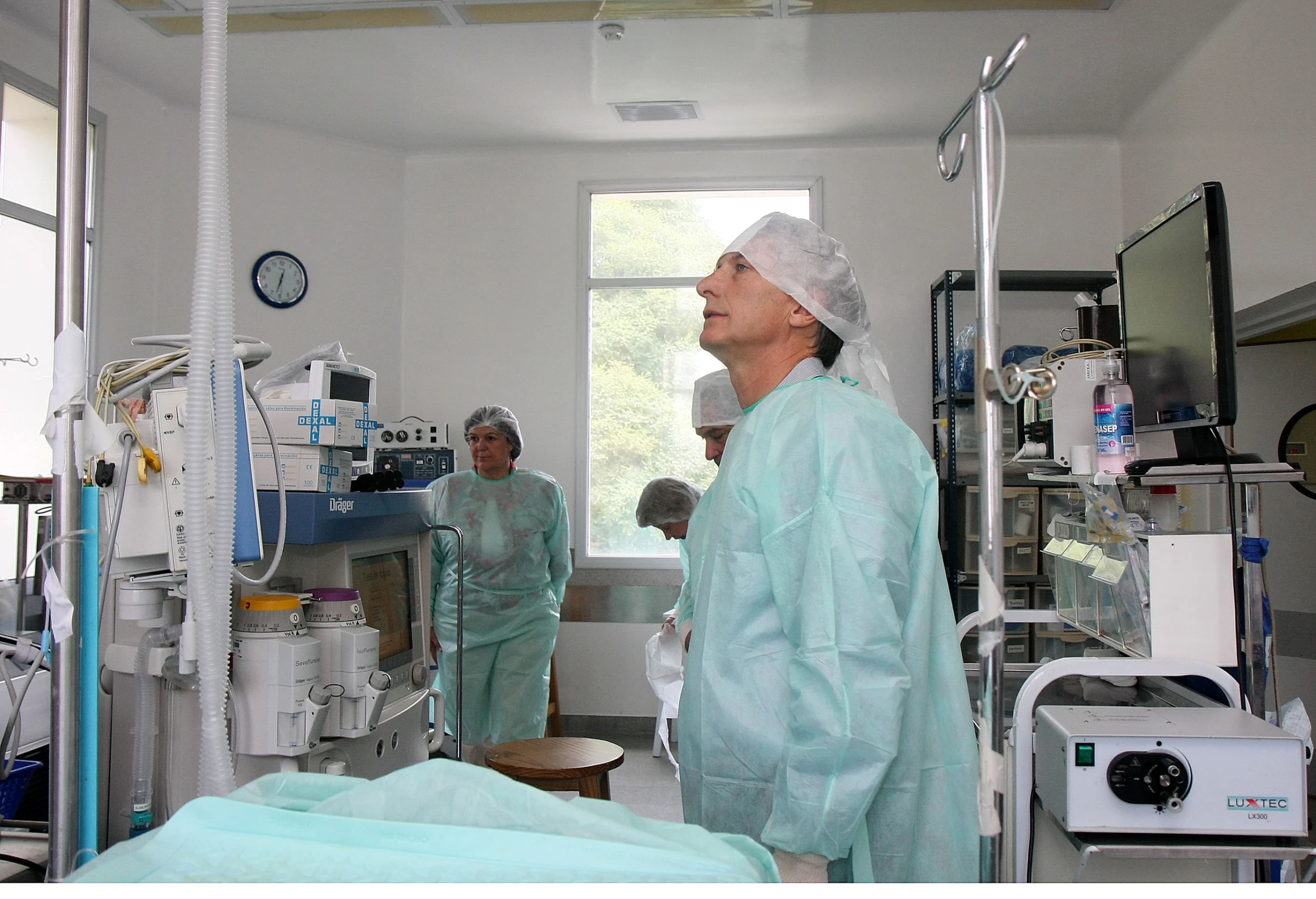 two doctors in scrubs stand inside an operating room