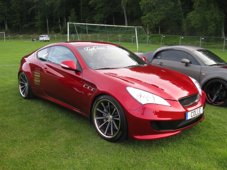 some nice looking cars parked on a grass field