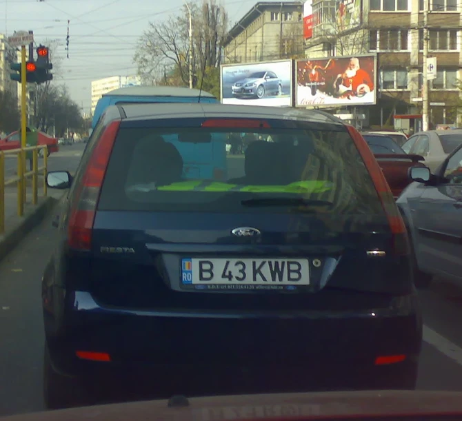 several cars driving down a city street