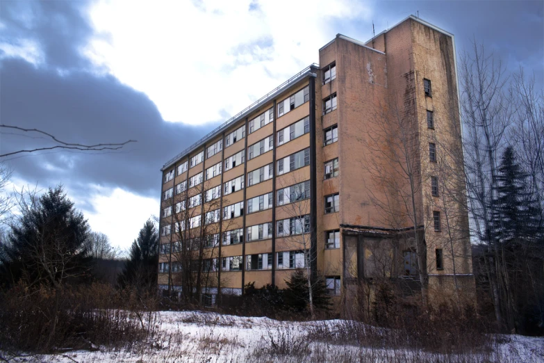 the building is very large and tall against the stormy sky