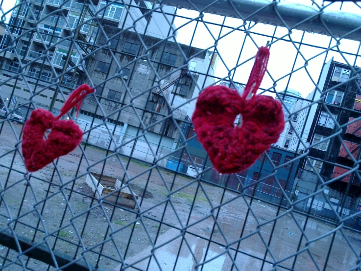 two heart shaped hearts on a fence