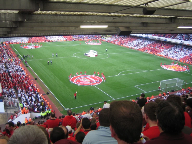 an overview of a soccer game being played in front of the audience