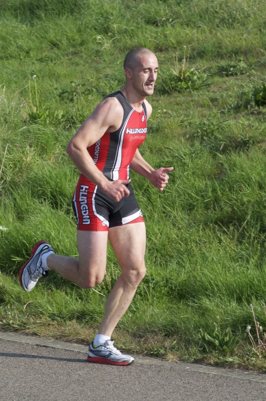 a man wearing a red and black bib running