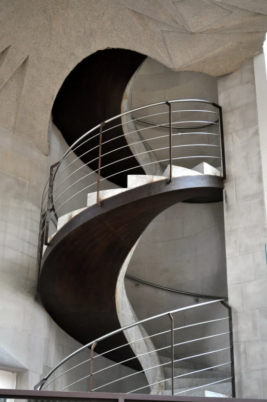 spiral stairs with railings and metal handrails in a room