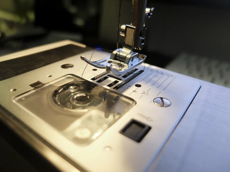 machine being sewn by a needle about to cross