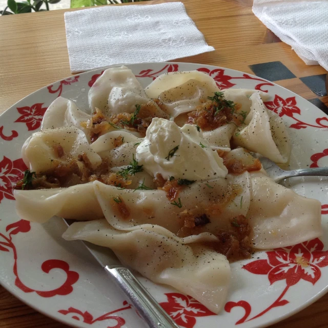 pasta and sauce sitting on a plate with a spoon