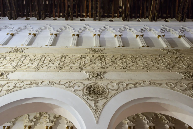 a building with columns and arches has intricate designs