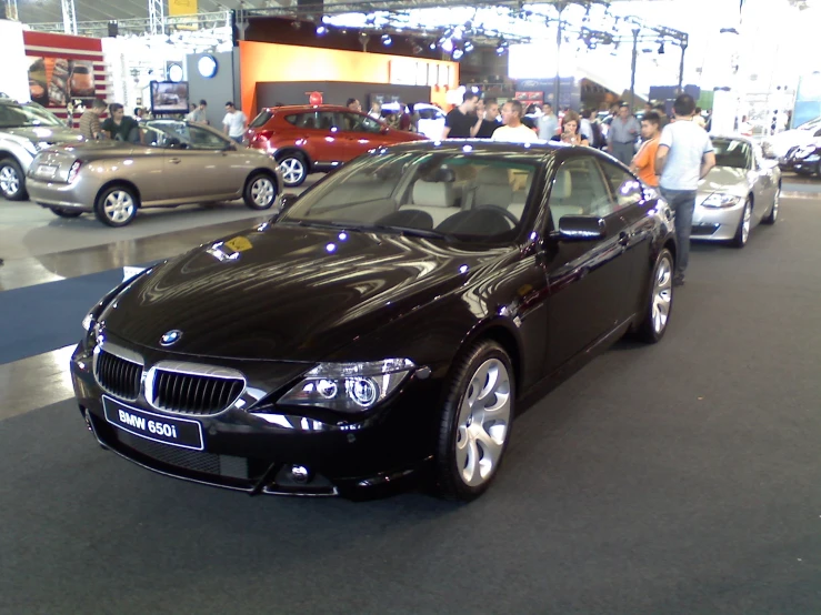 several cars are parked in a car showroom