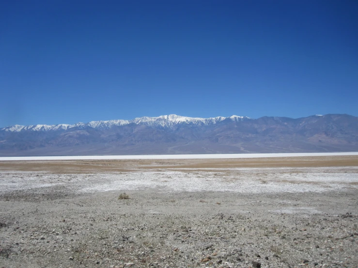 a large snowy mountain range is in the distance