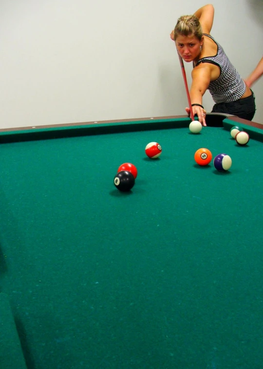 a lady leaning over to make the rounds on her billiard