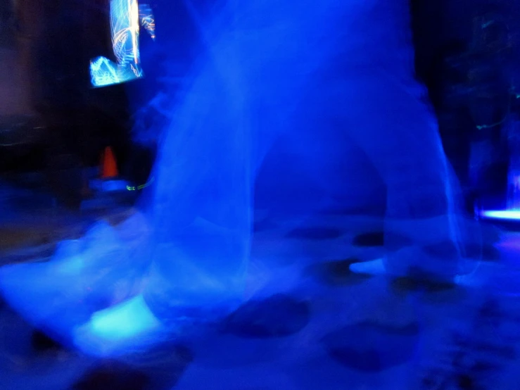 a blurry image of people on a sidewalk in blue light