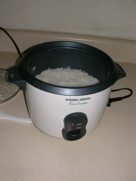 a slow cooker on a counter with food in it