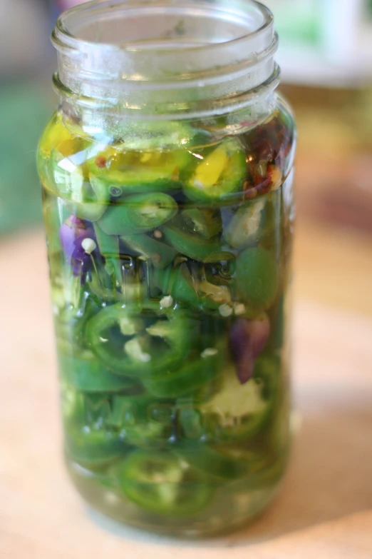 pickled vegetables mixed in jar on counter with other vegetables