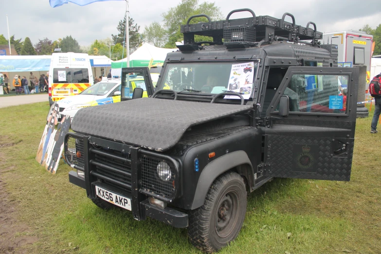 a military jeep is parked in the grass