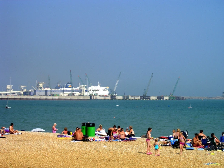 a group of people sitting on beach chairs near the water