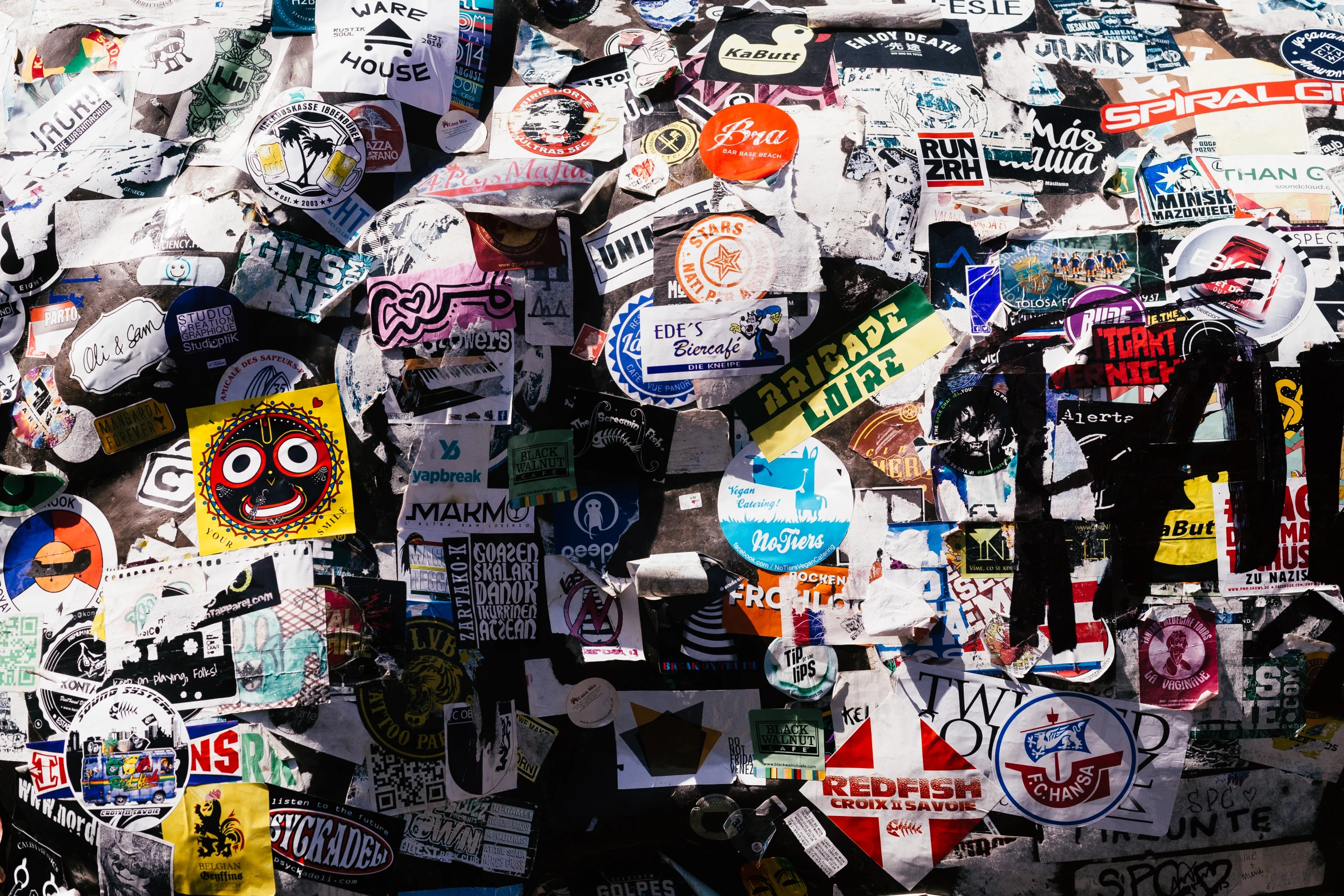 a bunch of different colored stickers hanging from the ceiling