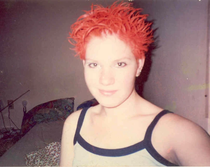 young woman with bright red hair, wearing tank top