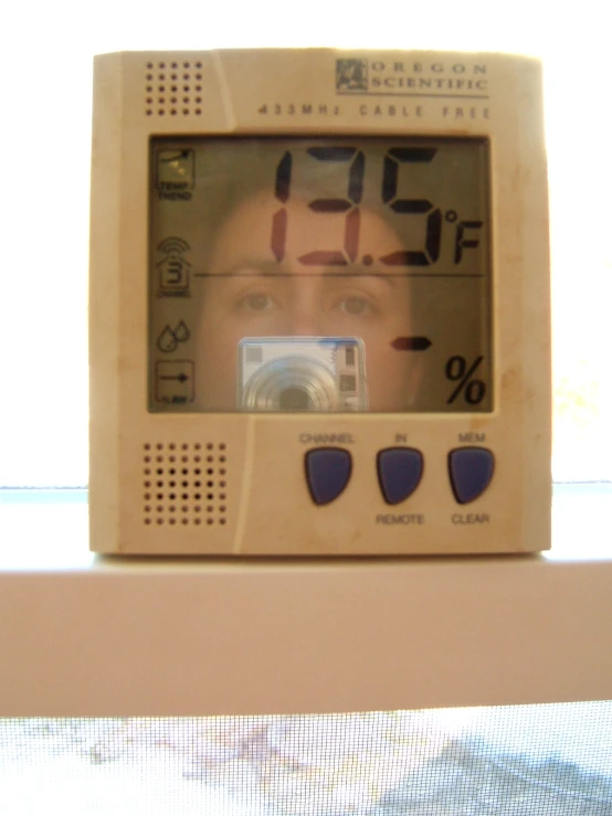 an old fashioned clock sitting on a shelf