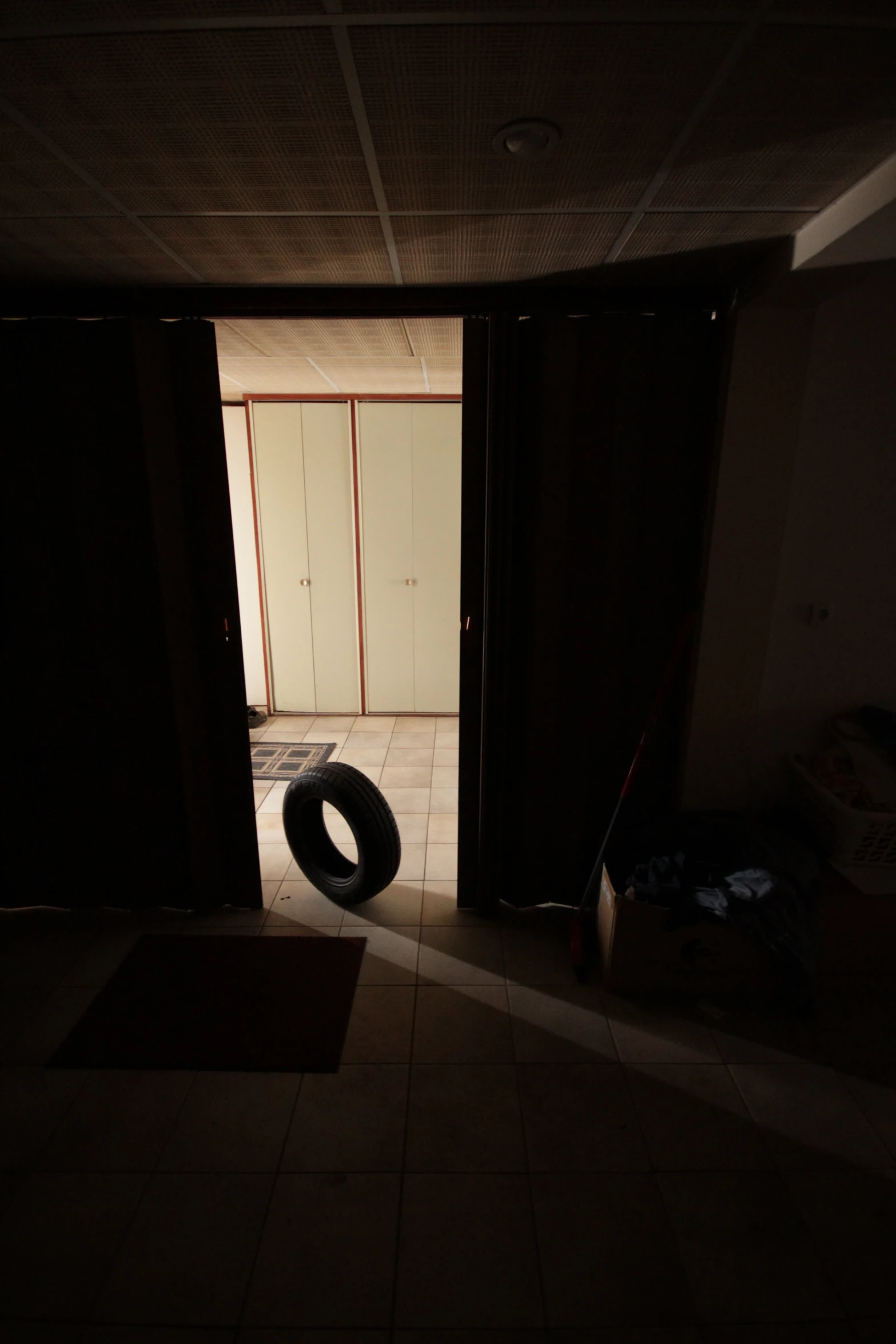 an inside of a dark room with a tire on the floor