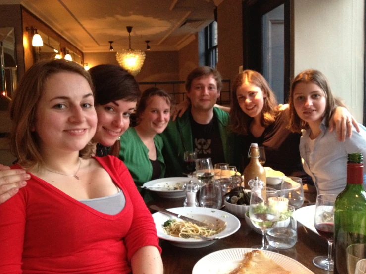 the people at a dinner are posing for a picture