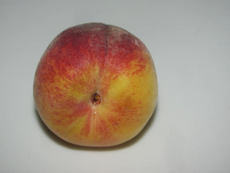 an image of the back end of a yellow and red apple