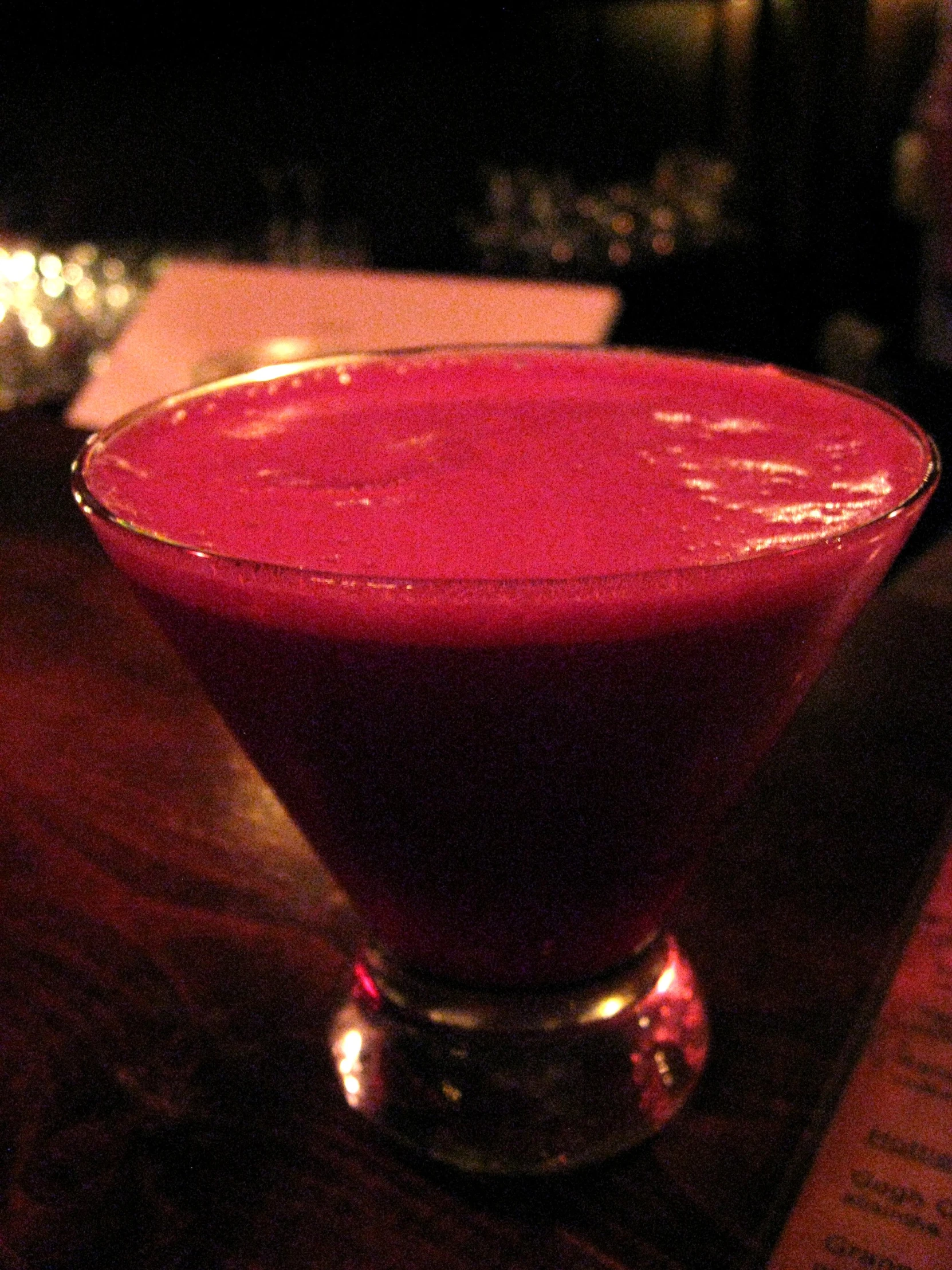 a dark, delicious drink is sitting on a table