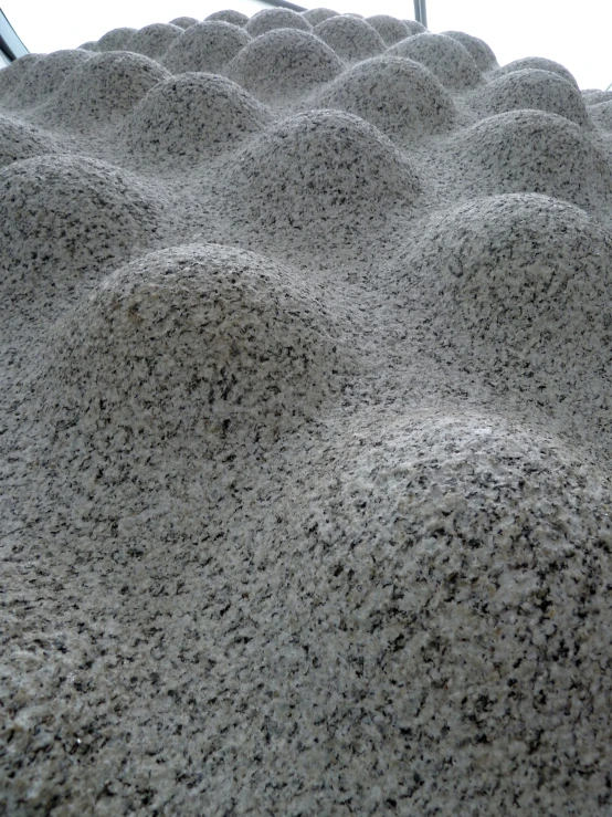 sand formations are standing upright with the sky reflected in them