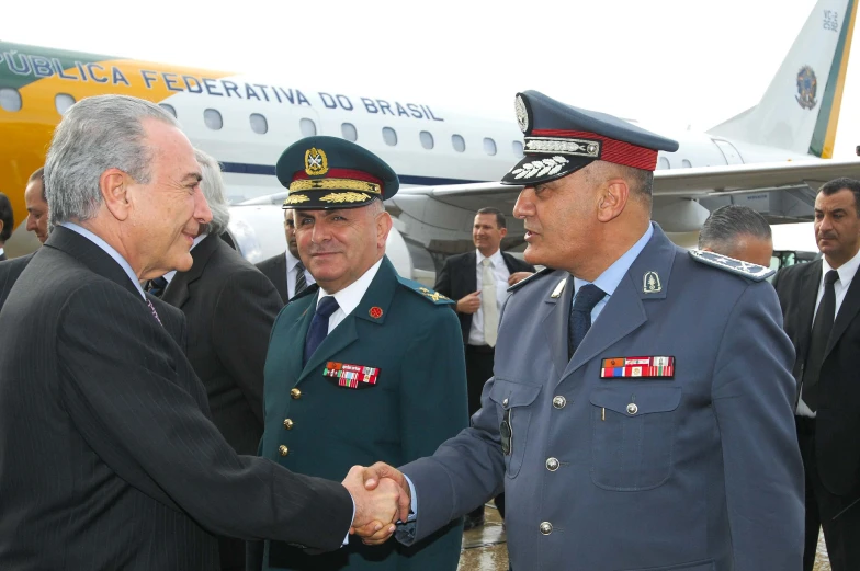 a couple of men shaking hands at an airport