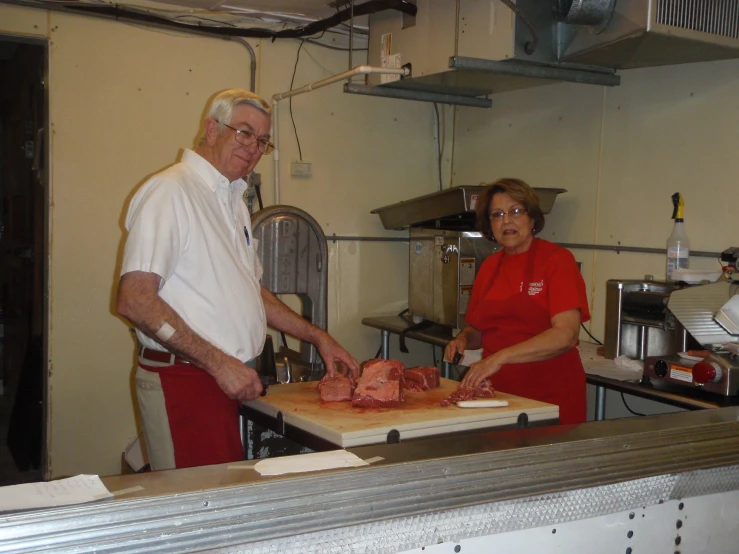 a man and woman  meat in the kitchen