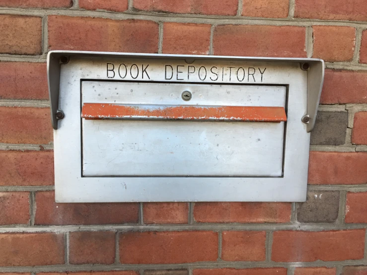 a picture of an old mail box on a brick wall