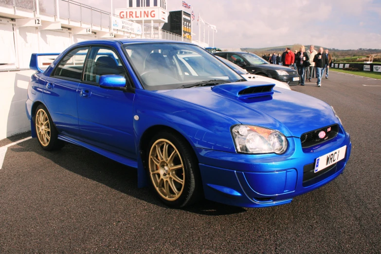 a blue subaruble car parked in a parking lot