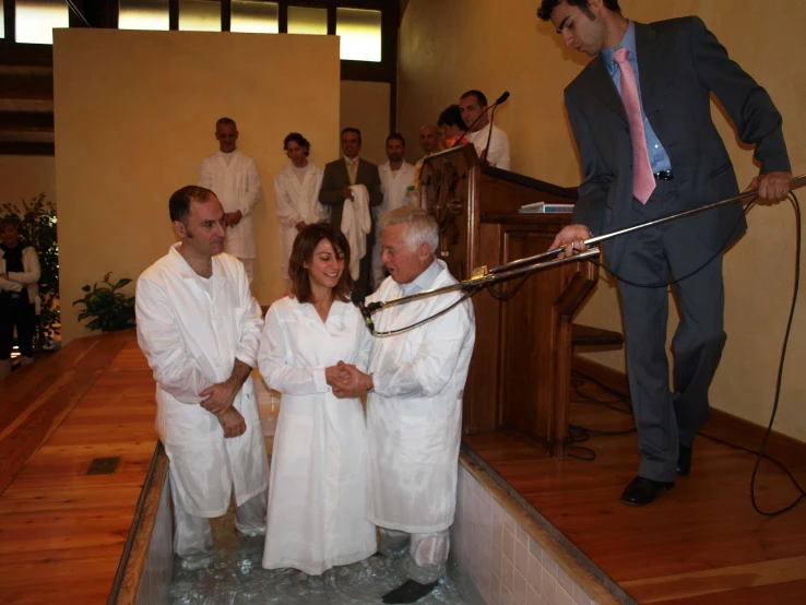 a group of people wearing bath robes are in the middle of a  tub