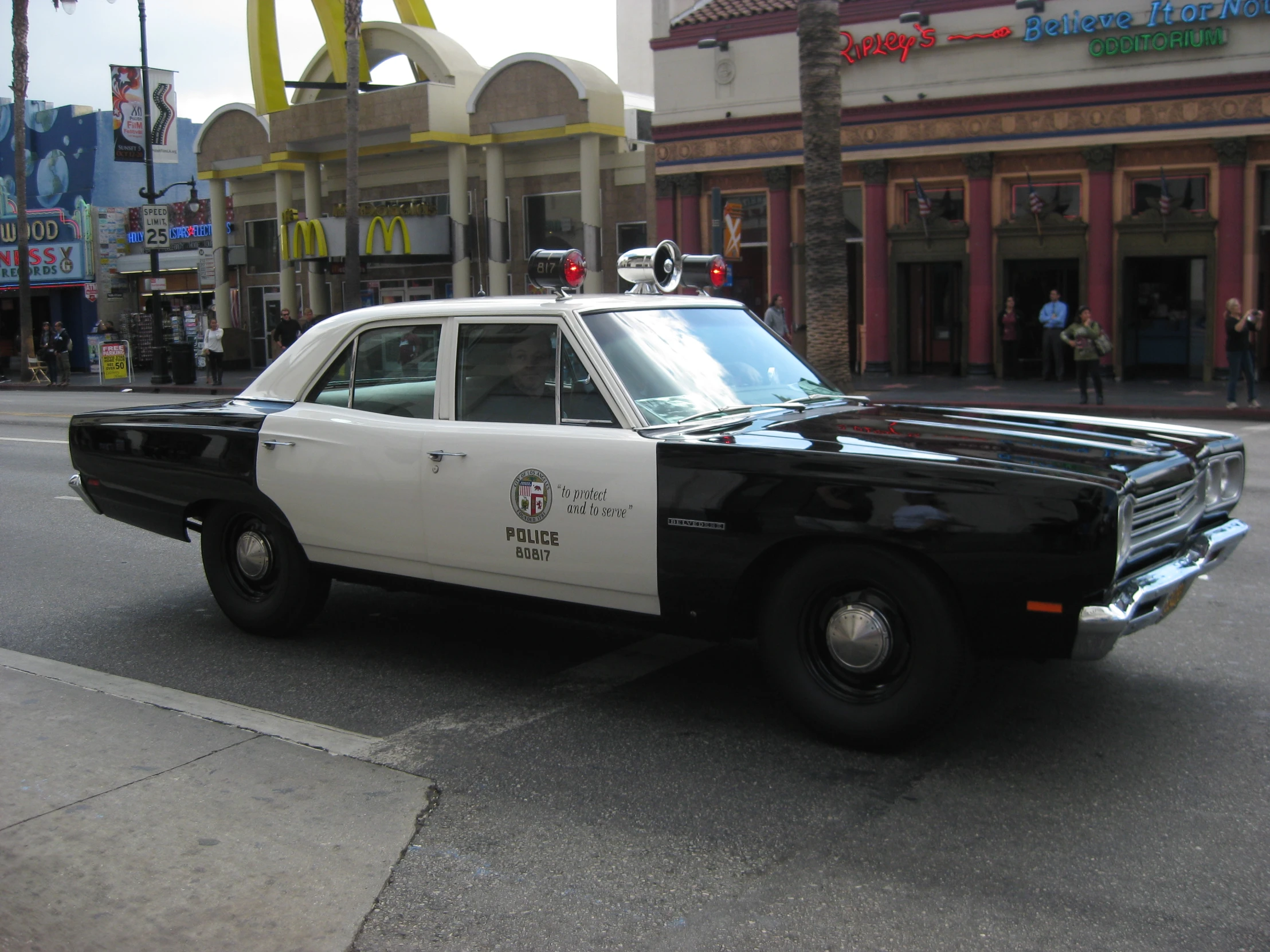 a black and white police car is parked on the street