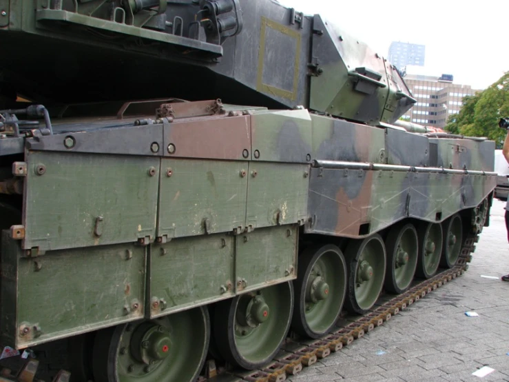 a group of large army trucks and vehicles parked on display