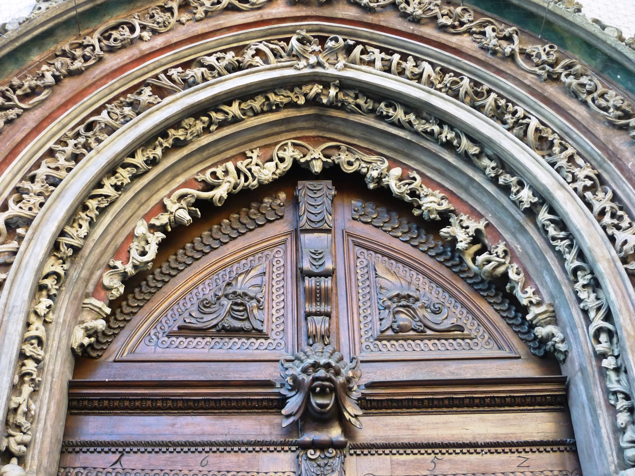 an elaborate wooden door that looks like a castle